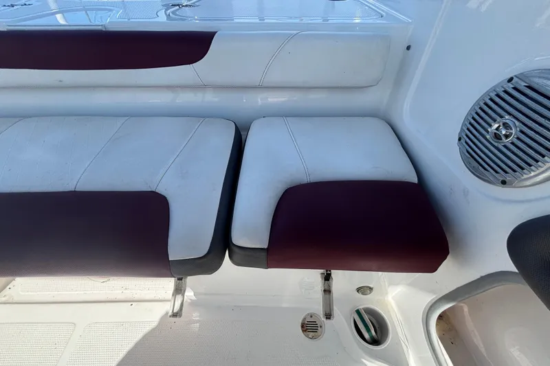 Slide: The Image of 2019 Tahoe 550 TF boat interior with white and maroon seating and speaker detail. - 54