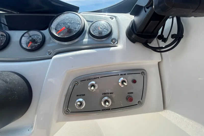 Slide: The Image of Dashboard controls of a 2019 Tahoe 550 TF boat, featuring gauges and switches. - 29