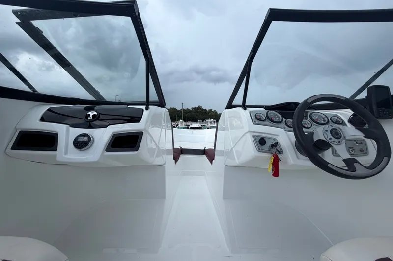 Slide: The Image of 2019 Tahoe 550 TS boat dashboard with steering wheel and gauges. - 31