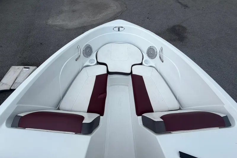 Slide: The Image of The bow of a 2019 Tahoe 550 TS with white and maroon seating. - 33