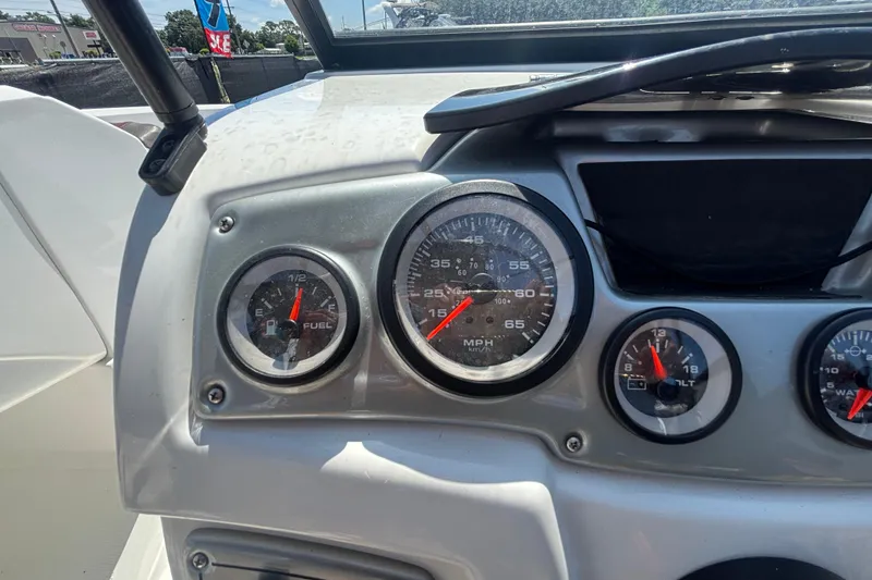Slide: The Image of Dashboard of a 2019 Tahoe 550 TF boat showing fuel and speed gauges. - 25
