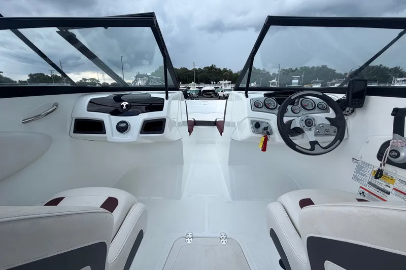Slide: The Image of Interior view of 2019 Tahoe 550 TS boat cockpit with steering wheel and dashboard. - 18