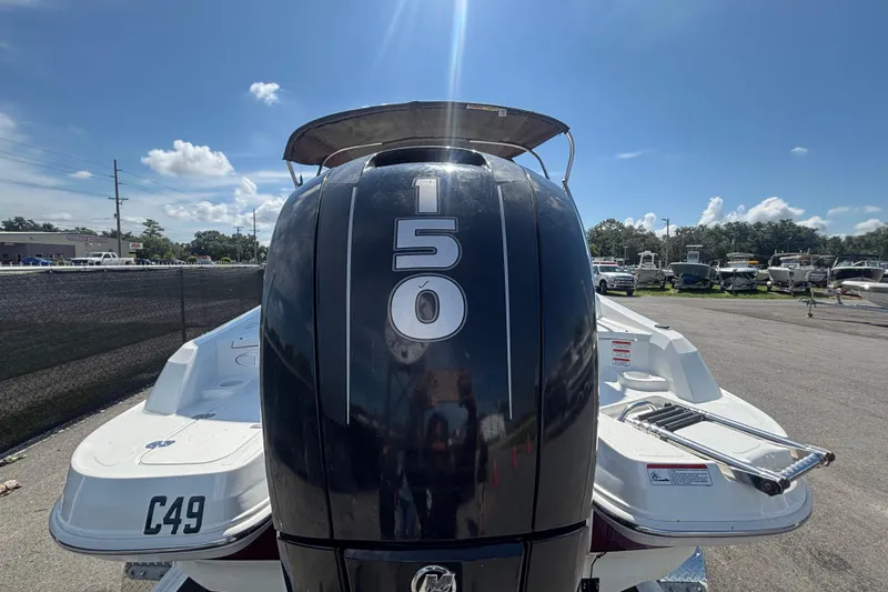 Slide: The Image of 2019 Tahoe 550 TF boat with powerful 150 engine, parked outdoors under clear skies. - 3
