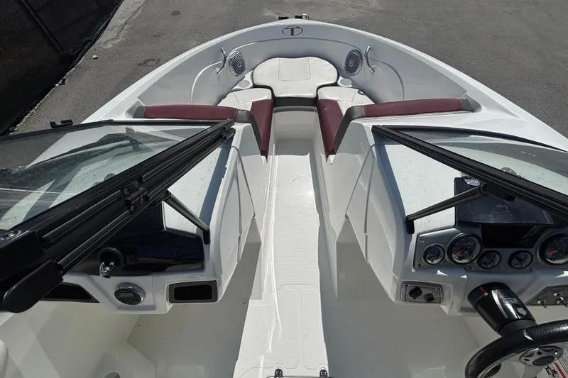 Slide: The Image of 2019 Tahoe 550 TF boat interior with maroon seating and dashboard controls. - 19