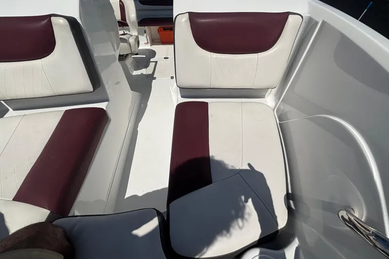 Slide: The Image of Interior seating of a 2019 Tahoe 550 TF boat with maroon and white upholstery. - 37