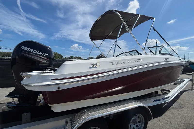 Slide: The Image of 2019 Tahoe 550 TF boat with Mercury engine on trailer under blue sky. - 2