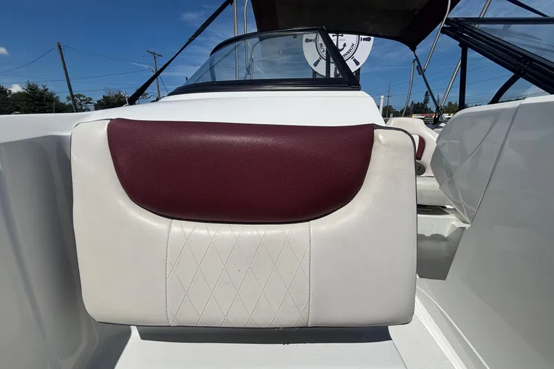 Slide: The Image of 2019 Tahoe 550 TF boat interior with maroon and white seating, under clear blue sky. - 41