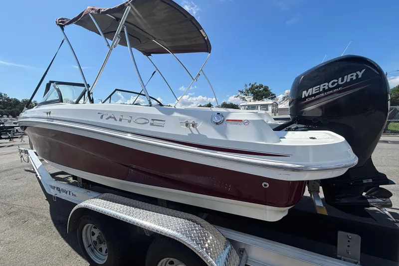 Slide: The Image of 2019 Tahoe 550 TF boat with Mercury engine on trailer, under clear blue sky. - 7