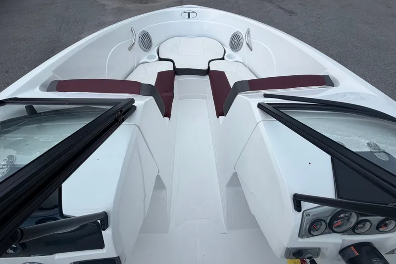 Slide: The Image of Interior view of a 2019 Tahoe 550 TS boat with maroon seating and dashboard controls. - 32