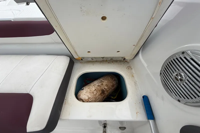 Slide: The Image of Storage compartment on a 2019 Tahoe 550 TS boat with a fender and speaker. - 57