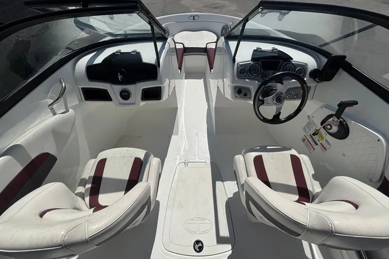 Slide: The Image of 2019 Tahoe 550 TF boat interior with steering wheel, dashboard, and seating. - 15