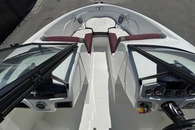 Slide: The Image of 2019 Tahoe 550 TF boat interior with maroon seating and dashboard controls. - 31