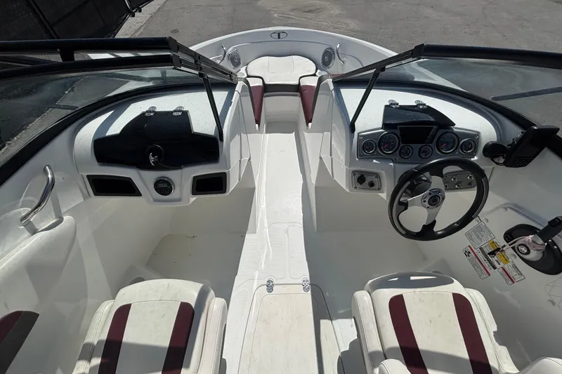 Slide: The Image of 2019 Tahoe 550 TF boat interior with steering wheel, dashboard, and seating. - 18
