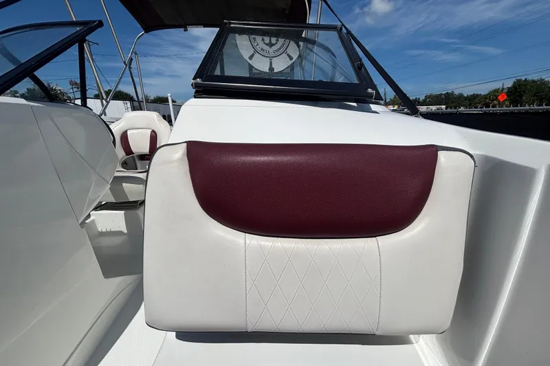 Slide: The Image of 2019 Tahoe 550 TF boat interior with maroon and white seating under a clear blue sky. - 43