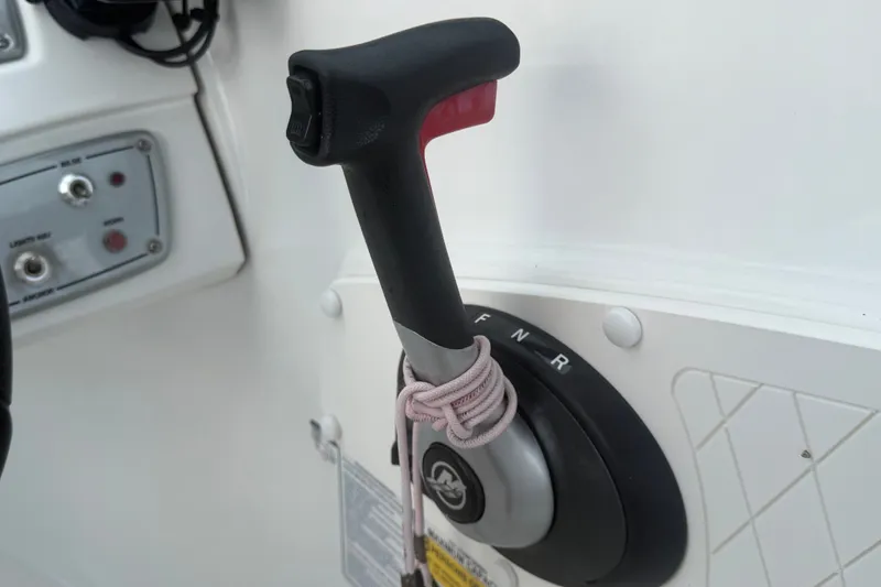 Slide: The Image of Throttle control lever on a 2019 Tahoe 550 TS boat dashboard. - 30