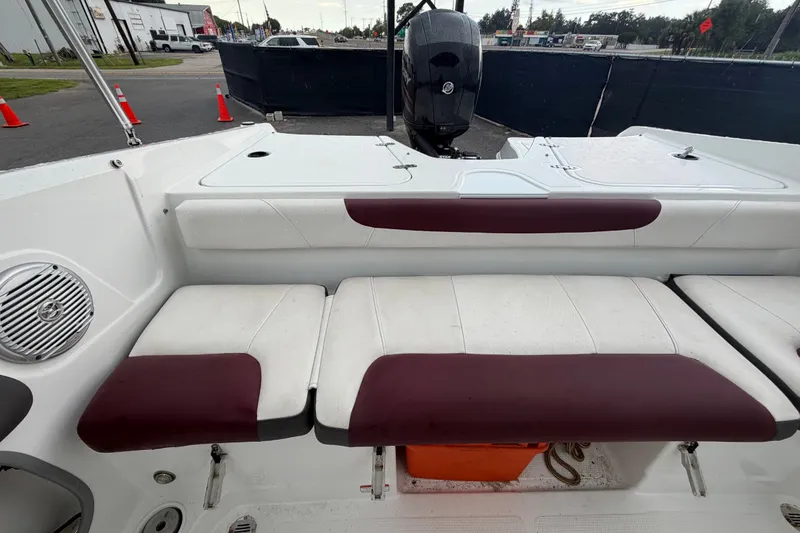 Slide: The Image of Interior view of a 2019 Tahoe 550 TS boat with white and maroon seating. - 52