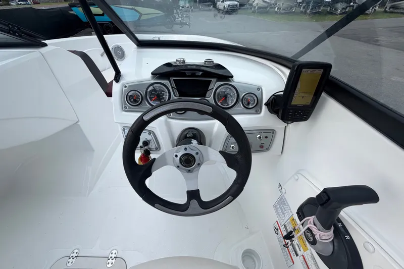 Slide: The Image of 2019 Tahoe 550 TS boat dashboard with steering wheel and navigation system. - 24