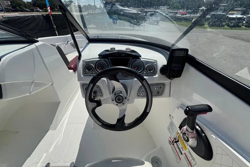 Slide: The Image of Interior view of 2019 Tahoe 550 TF boat cockpit with steering wheel and controls. - 23