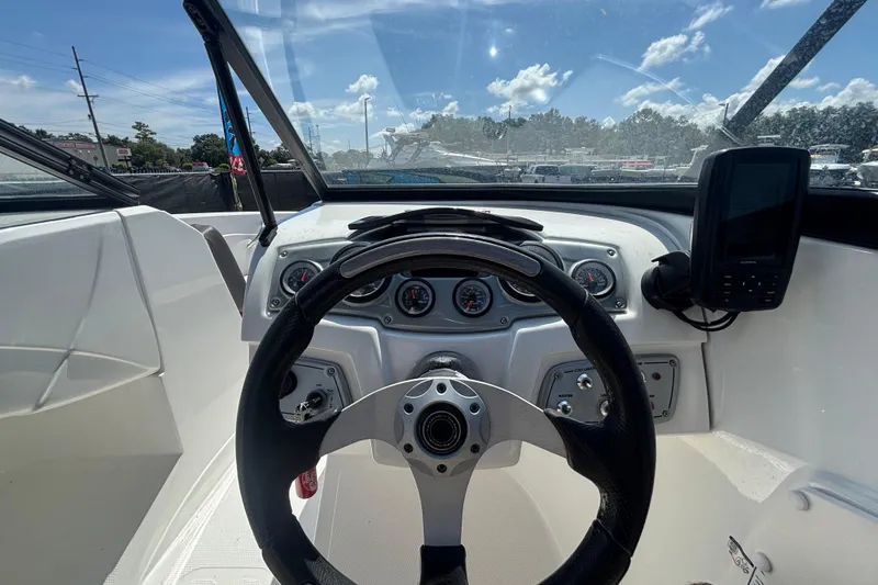 Slide: The Image of Interior view of 2019 Tahoe 550 TF boat dashboard with steering wheel and gauges. - 24
