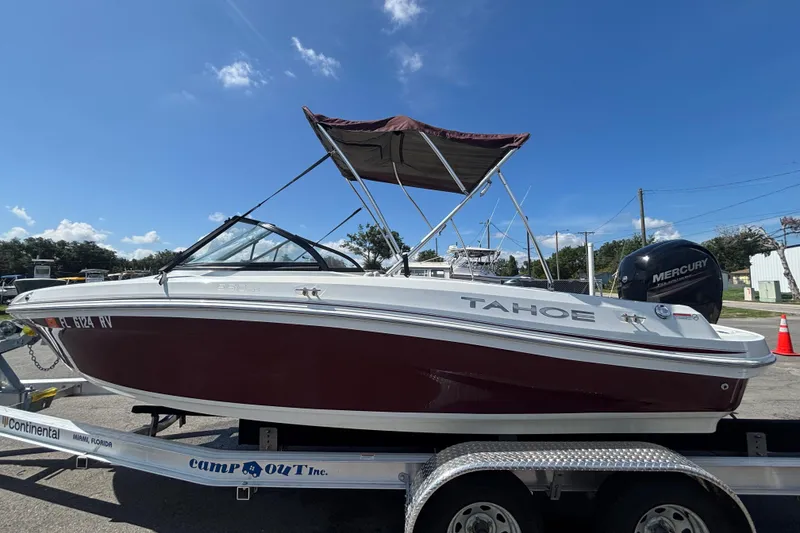 Slide: The Image of 2019 Tahoe 550 TF boat on trailer, featuring a Mercury outboard motor. - 8