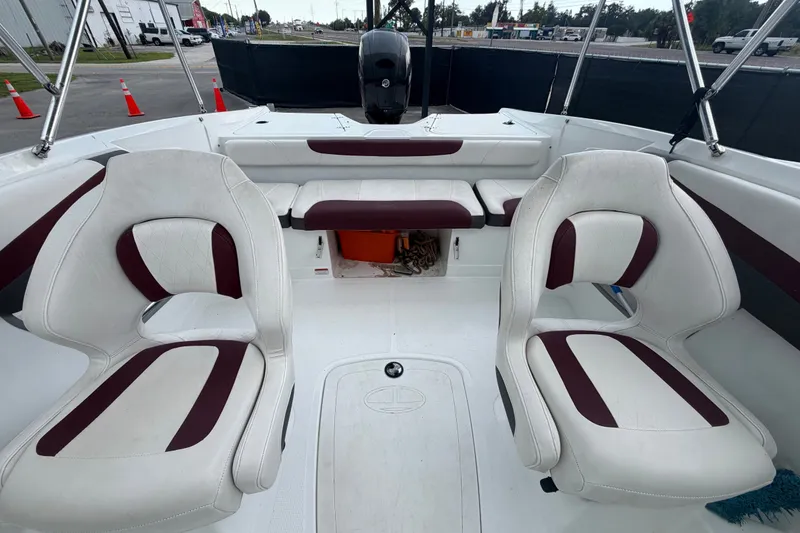 Slide: The Image of 2019 Tahoe 550 TS boat interior with white and maroon seating, showcasing modern design. - 48