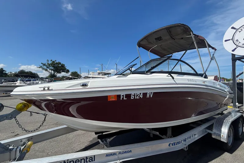 Slide: The Image of 2019 Tahoe 550 TF boat on trailer, Miami, Florida, under clear blue sky. - 9