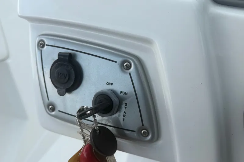 Slide: The Image of Control panel of a 2019 Tahoe 550 TS boat with ignition and 12V outlet. - 28
