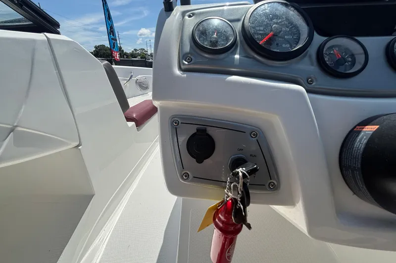 Slide: The Image of Dashboard of a 2019 Tahoe 550 TF boat with ignition keys and gauges. - 28