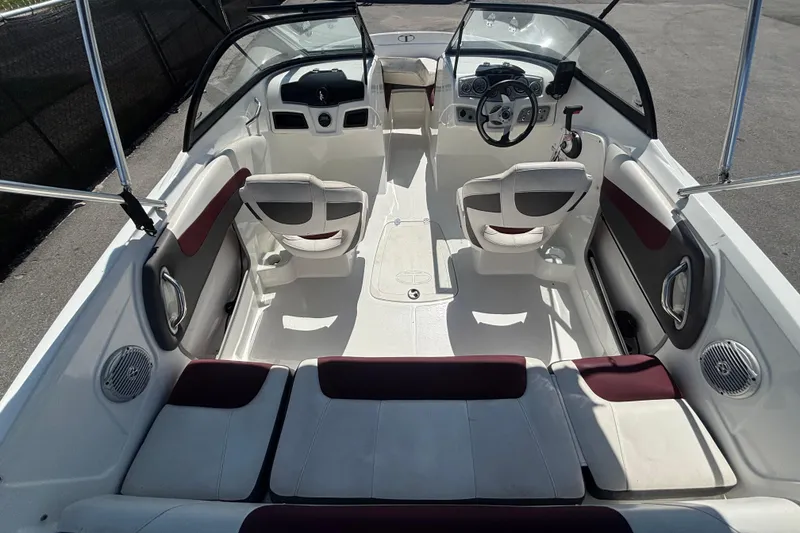 Slide: The Image of 2019 Tahoe 550 TF boat interior with seating, steering wheel, and dashboard controls. - 13