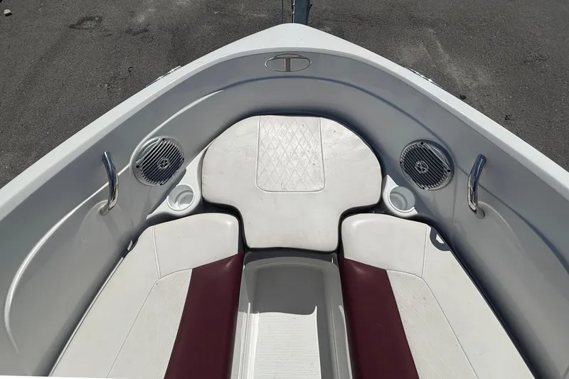 Slide: The Image of The image shows the bow area of a 2019 Tahoe 550 TF boat with red and white seating. - 33