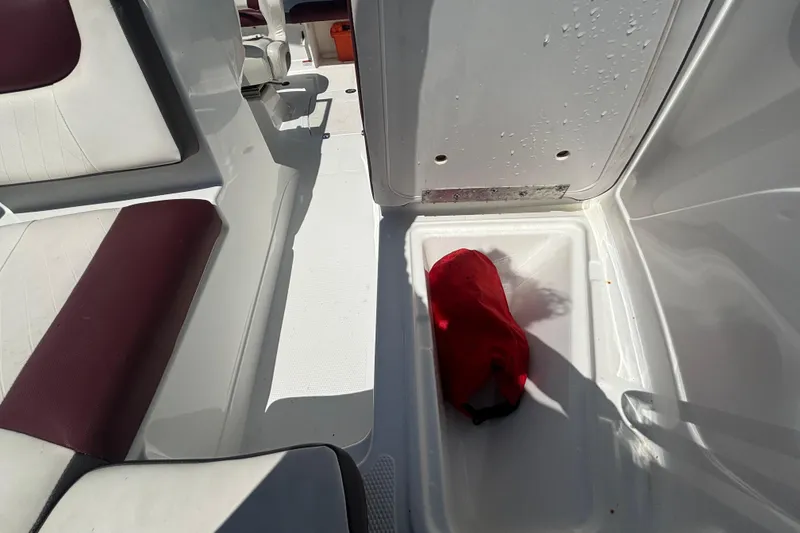 Slide: The Image of Interior of a 2019 Tahoe 550 TF boat with red and white seating. - 38