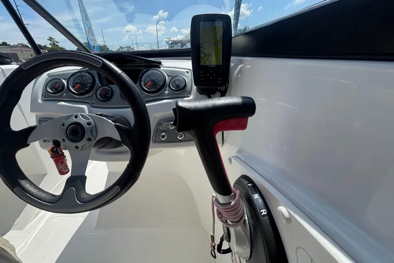 Slide: The Image of 2019 Tahoe 550 TF boat dashboard with steering wheel, throttle, and navigation display. - 30