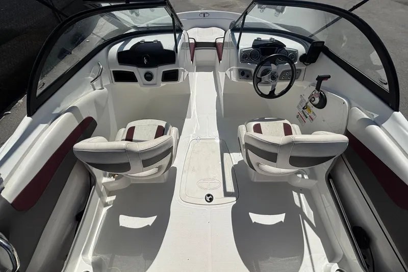 Slide: The Image of 2019 Tahoe 550 TF boat interior with dual seats and steering console. - 14