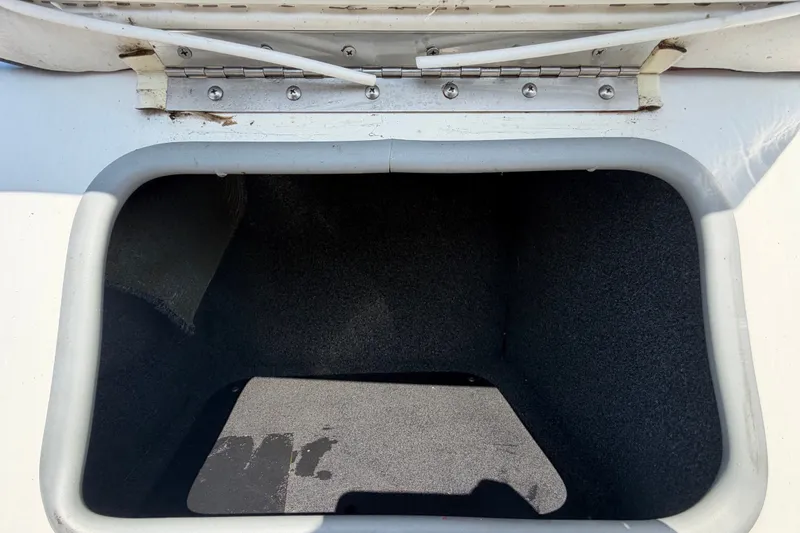 Slide: The Image of An open storage compartment on a boat with a gray interior. - 46