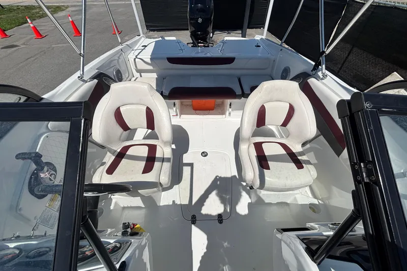 Slide: The Image of 2019 Tahoe 550 TF boat interior with dual white seats and steering console. - 46
