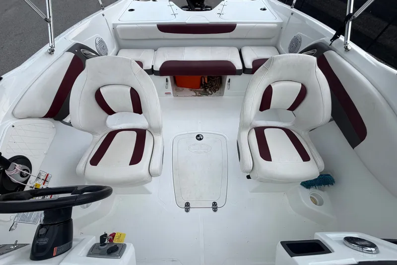 Slide: The Image of Interior of a 2019 Tahoe 550 TS boat with white and maroon seating. - 47