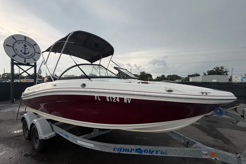 The Image of 2019 Tahoe 550 TS boat on trailer, parked outdoors under cloudy sky. - 0