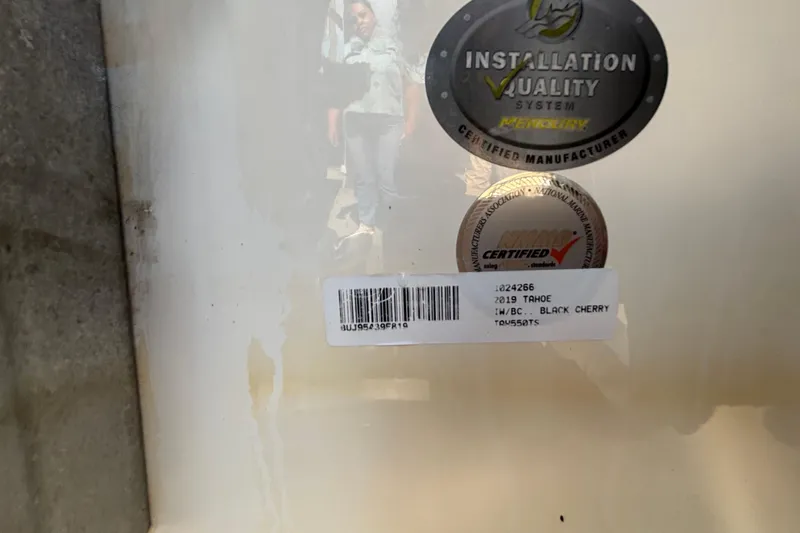 Slide: The Image of 2019 Tahoe 550 TF certification stickers and barcode on a white surface. - 62