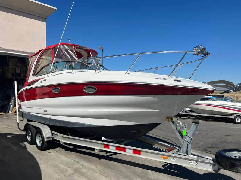 The Image of 2007 Crownline 250 CR boat on a trailer with red and white exterior. - 1