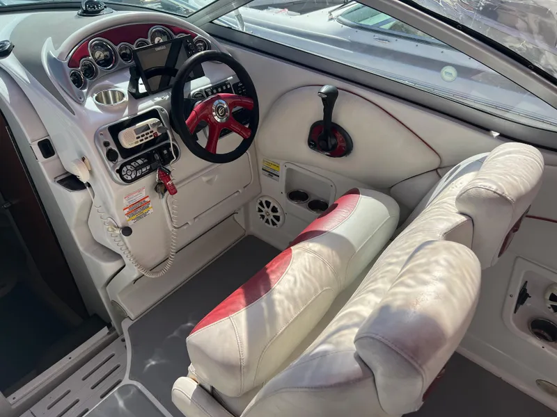 Slide: The Image of 2007 Crownline 250 CR boat cockpit with steering wheel and control panel. - 11