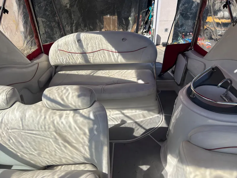 Slide: The Image of Interior of a 2007 Crownline 250 CR boat with white leather seating. - 13