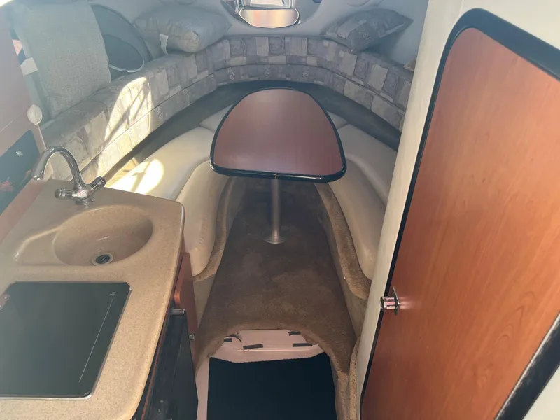 Slide: The Image of 2007 Crownline 250 CR cabin interior with kitchenette and seating area. - 15
