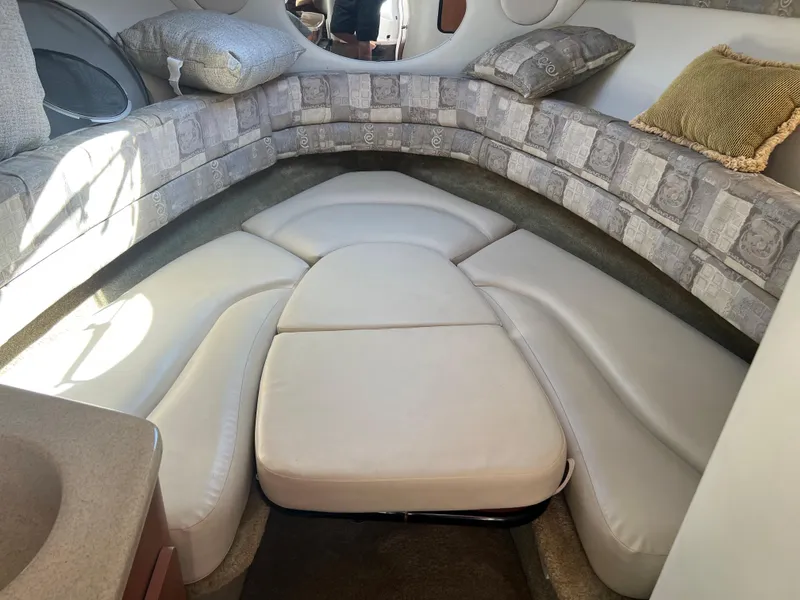 Slide: The Image of 2007 Crownline 250 CR boat interior with cushioned seating and pillows. - 19