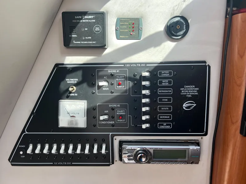 Slide: The Image of Control panel of a 2007 Crownline 250 CR boat with various switches and gauges. - 21