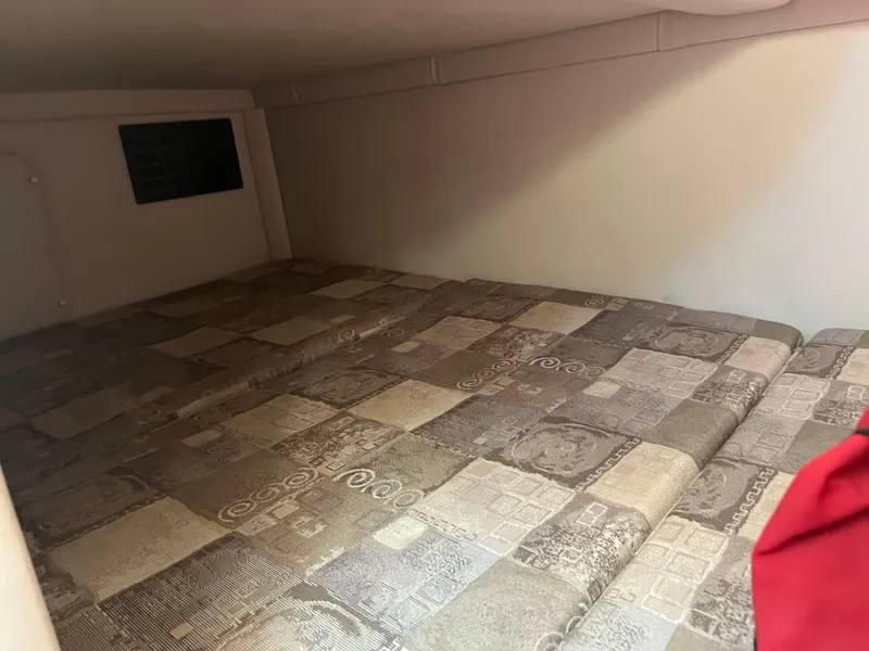 Slide: The Image of Interior cabin bed of 2007 Crownline 250 CR boat with patterned bedding. - 23