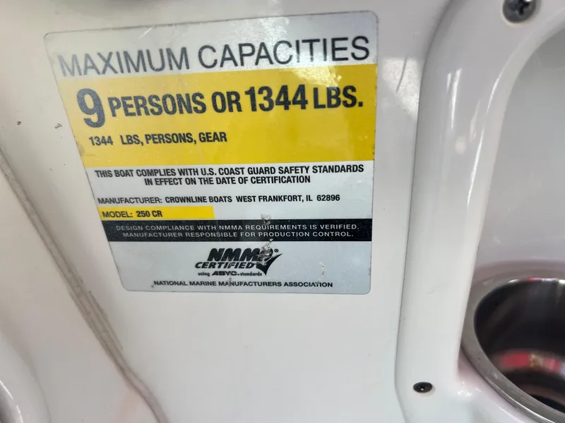 Slide: The Image of Maximum capacity label on a 2007 Crownline 250 CR boat, 9 persons or 1344 lbs. - 25