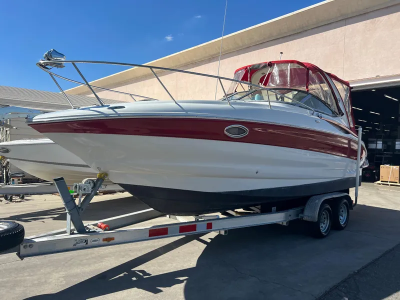 Slide: The Image of 2007 Crownline 250 CR boat on a trailer with red and white exterior. - 3