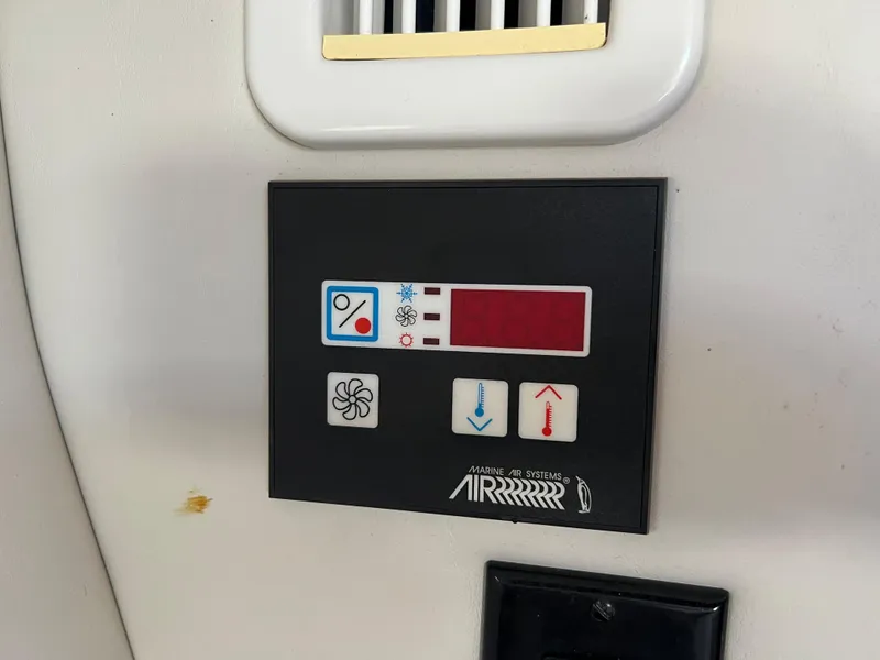 Slide: The Image of 2007 Crownline 250 CR boat air conditioning control panel. - 30