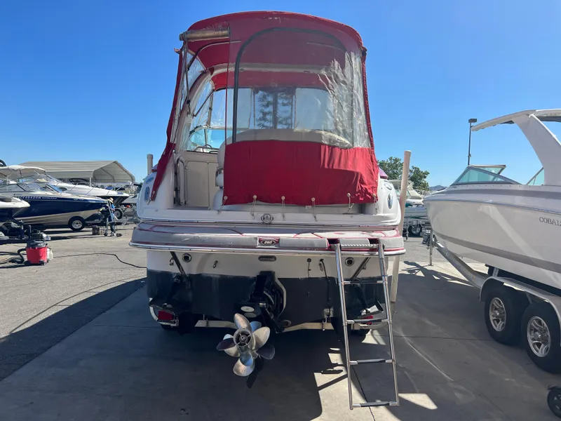 Slide: The Image of 2007 Crownline 250 CR boat with red canopy, docked at marina. - 6