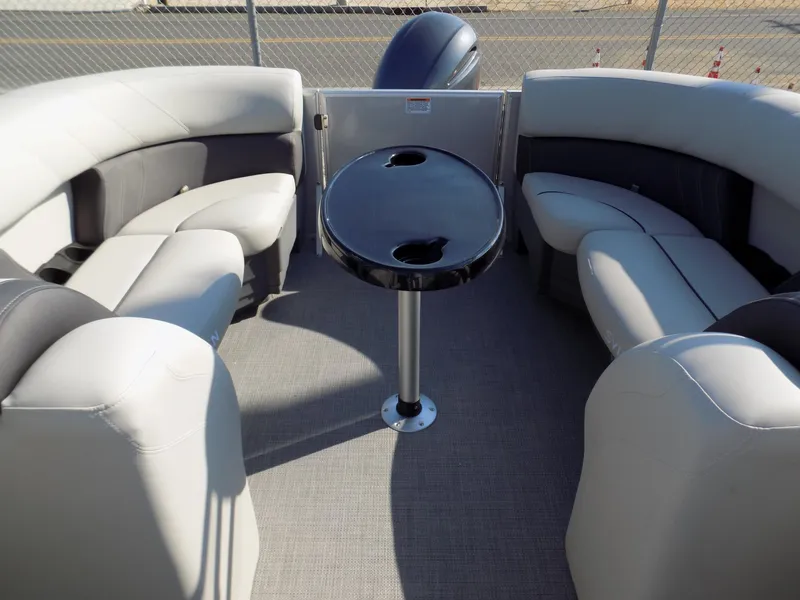 Slide: The Image of 2023 Sylvan Mirage 8522 LZ pontoon boat interior with plush seating and central table. - 7